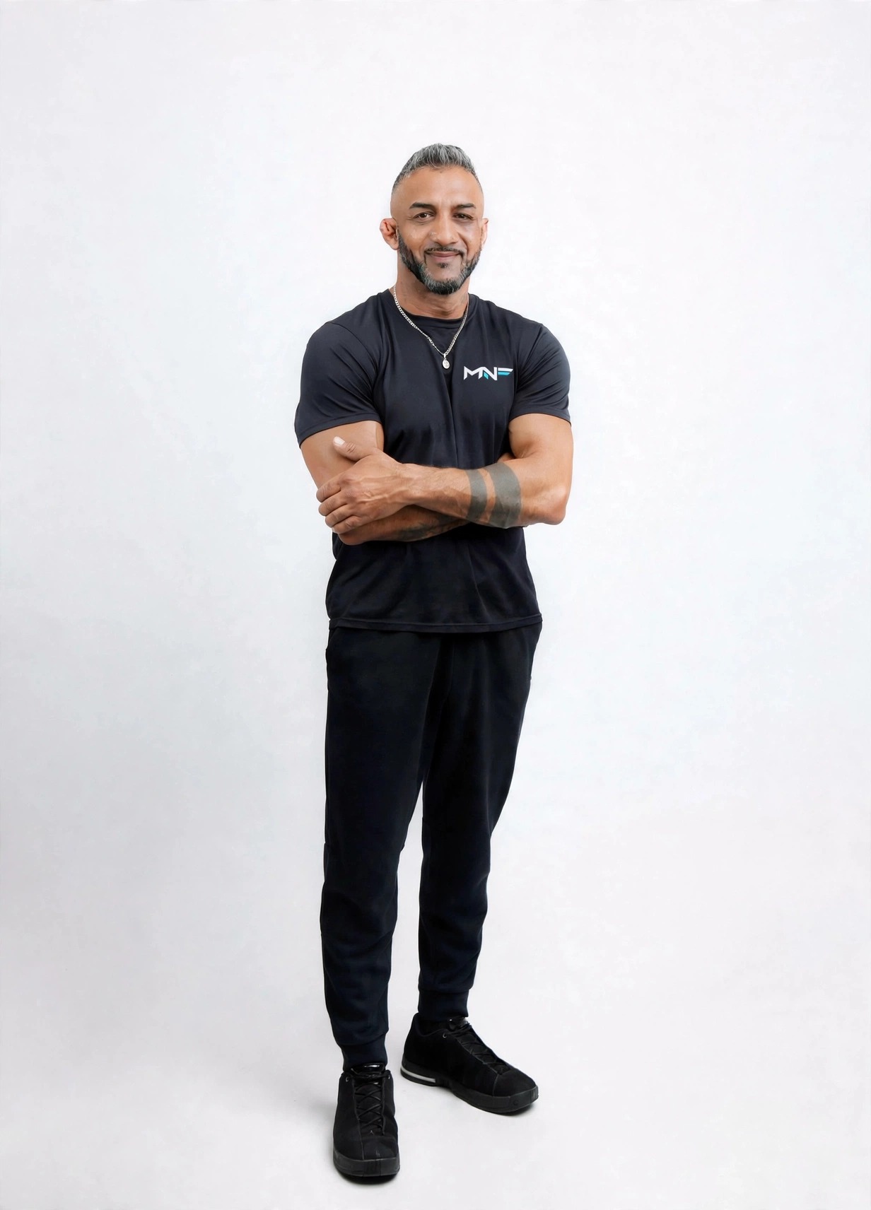 Manj Nijjar standing confidently in black training clothes